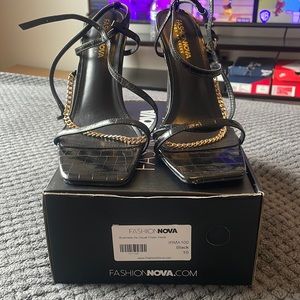 Fashion nova black strap heels with gold chain.